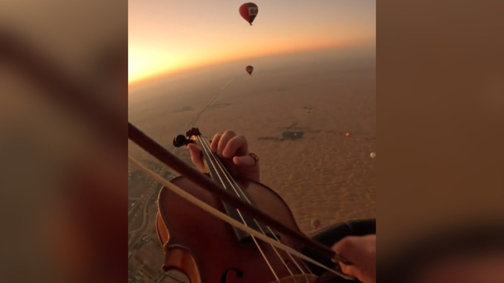 View from a violinist giving a violin concert from an air balloon.
