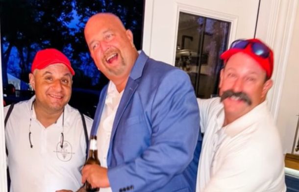 Image shows a groom with his two friends after they crashed his wedding.