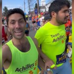 Nev Schulman smiles as him and a blind athlete run in the Boston Marathon