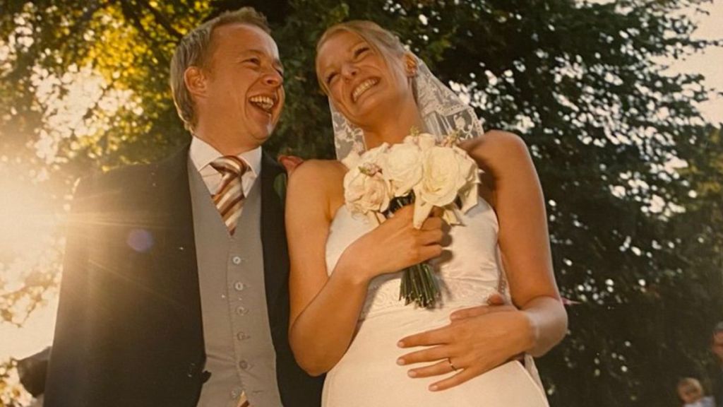 A happy couple smiling on their wedding day.