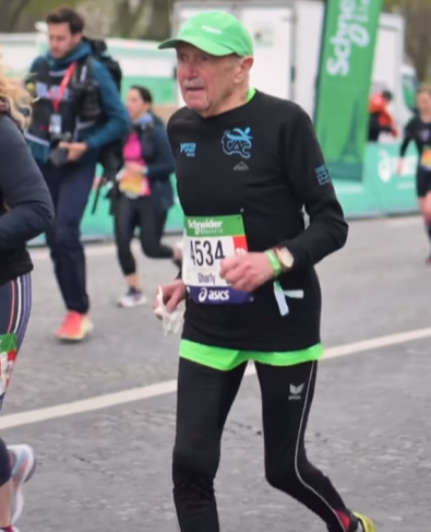 Charly Bancarel wearing black and running in a marathon.