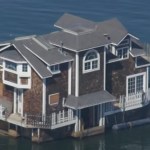 Close-up view of a two-story home floating down the San Francisco Bay.