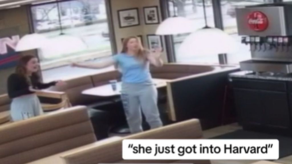 A girl points excitedly to her friend in a Dairy Queen.