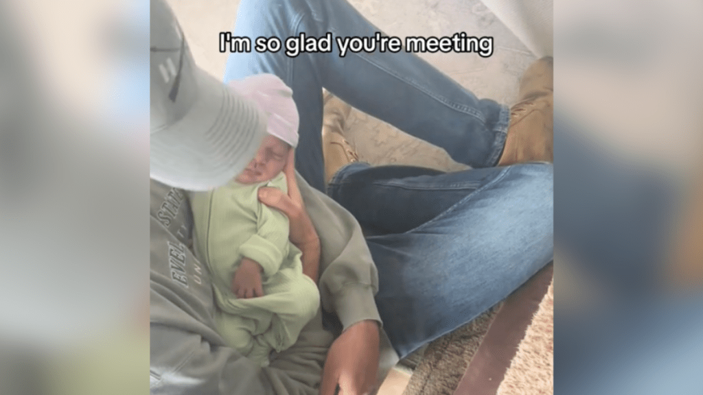 man holding newborn baby