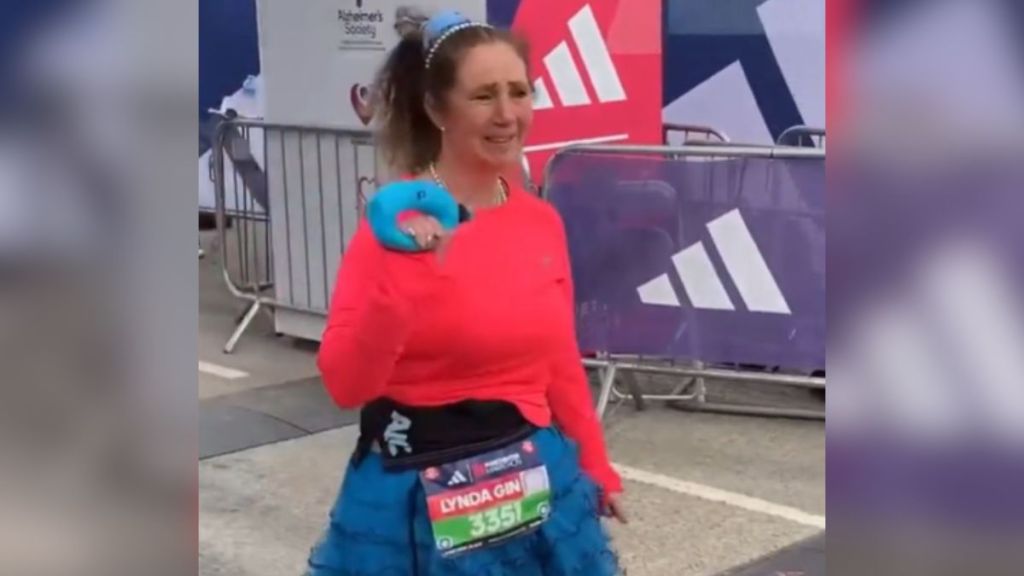 A woman is emotional as she crosses the Manchester Marathon finish line.