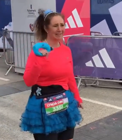 A woman is emotional as she crosses the Manchester Marathon finish line.