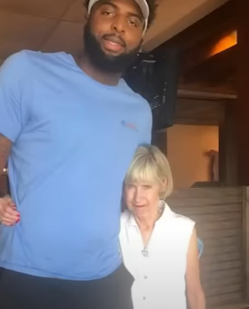 Mitchell Robinson smiles as he poses with Butch Stockton's wife.