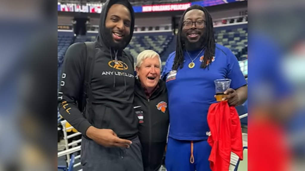 Butch Stockton smiles wide as he poses with Mitchell Robinson and another man.