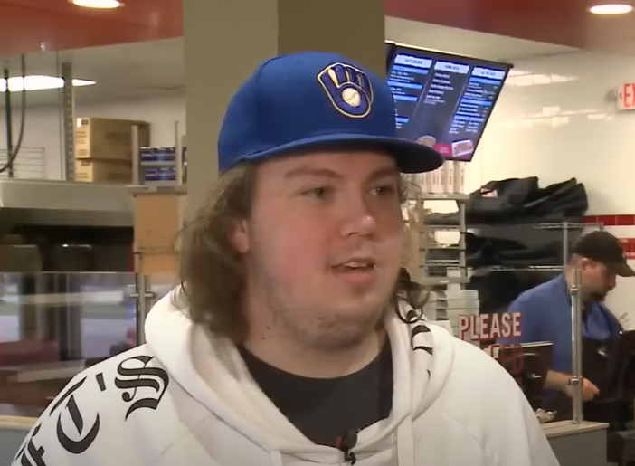 A pizza guy wearing a Taylor Swift hoodie.