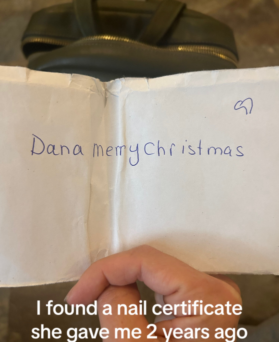 A woman holds up an envelope with a handwritten note that reads: Dana Merry Christmas
Text on the image: I found a nail certificate she gave me 2 years ago