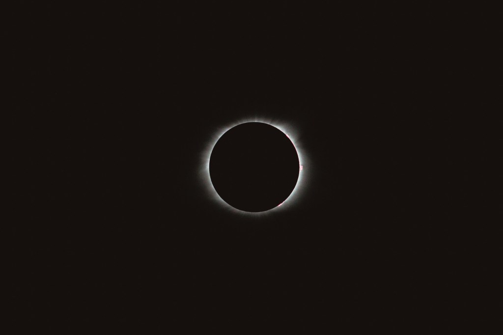 A ring of light black sky during a solar eclipse.
