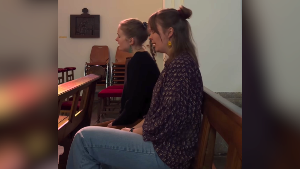 two women singing the cranberries' dreams in church