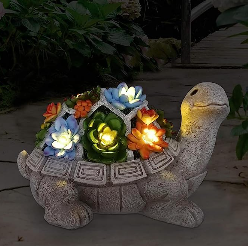 An outdoor turtle statue with light bulbs in the shell.