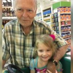 Dan and Norah, and 82 and 4 year old, smile as they pose in a grocery store.