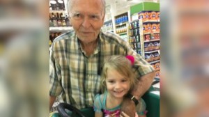 Dan and Norah, and 82 and 4 year old, smile as they pose in a grocery store.