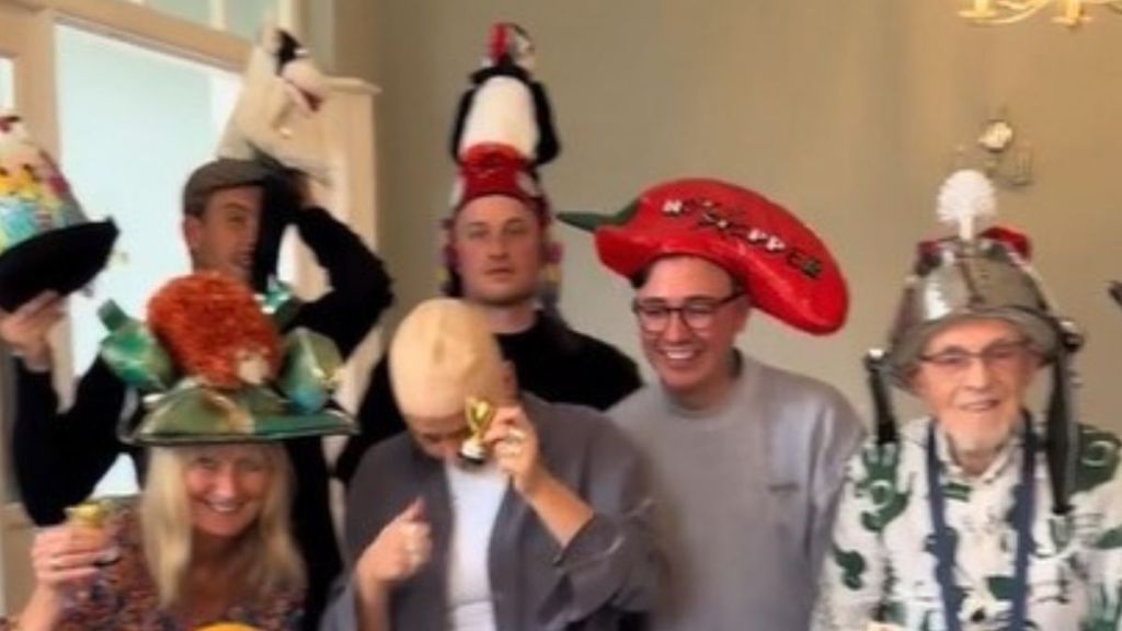 Image shows a family wearing crazy hats at a gathering.