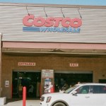 Exterior view of a Costco with a white vehicle parked outside.