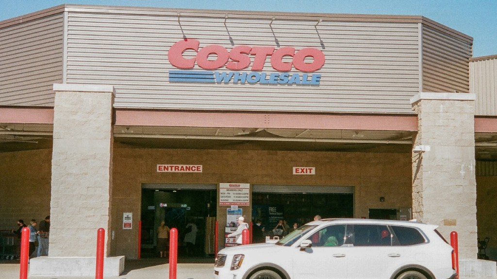 Exterior view of a Costco with a white vehicle parked outside.