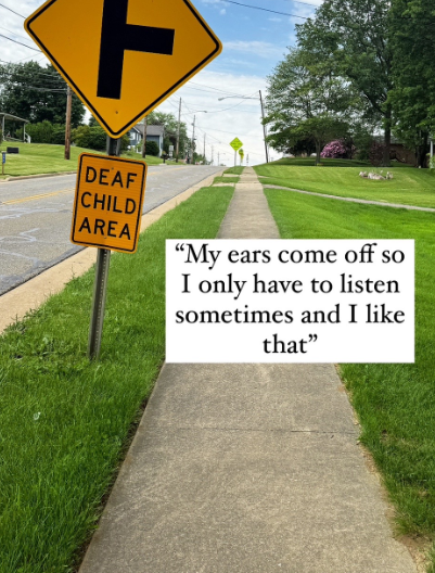 A neighborhood street with a quote from a deaf boy.