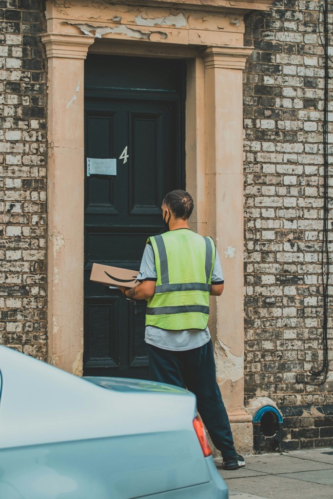 A delivery driver dropping off a package. 