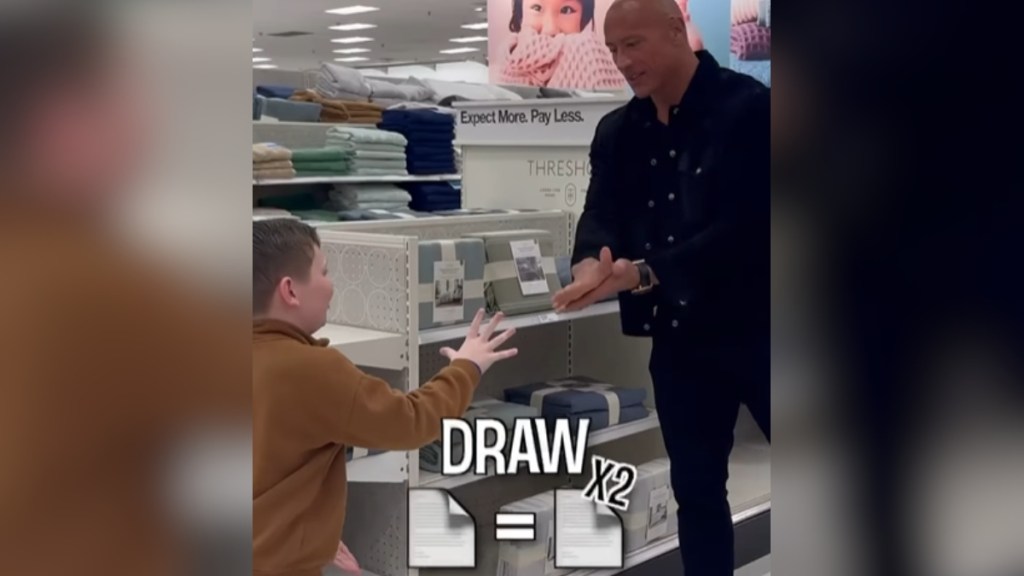 A little kid and Dwayne "The Rock" Johnson play rock, paper, scissors in a Target. Text on the image reads "Draw x2" along with two paper emojis.