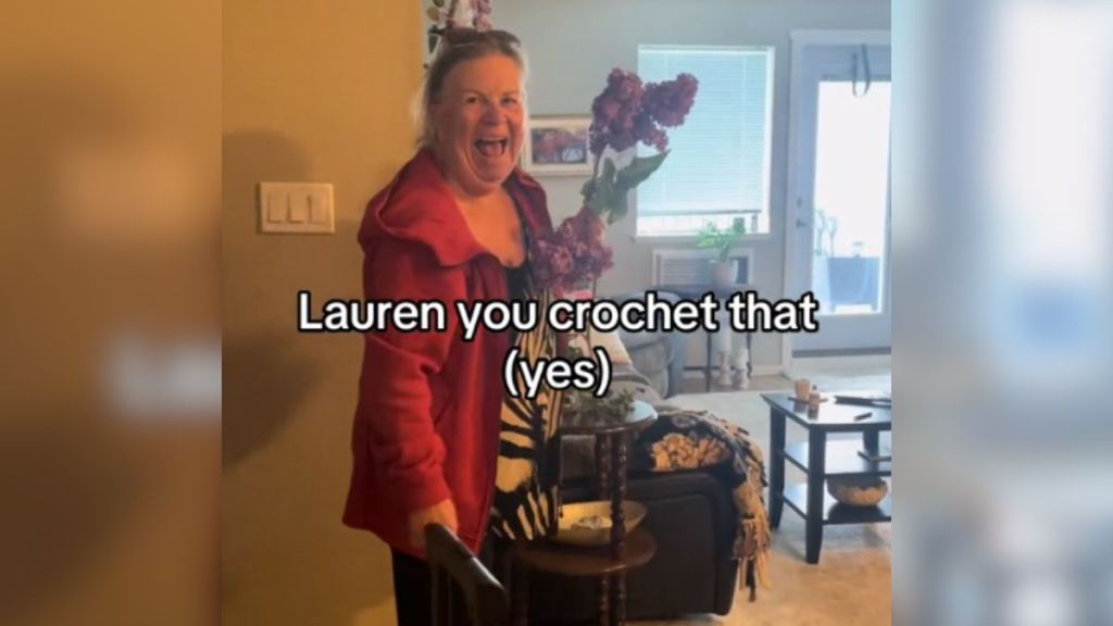 A woman holding a bunch of flowers and looking excited.