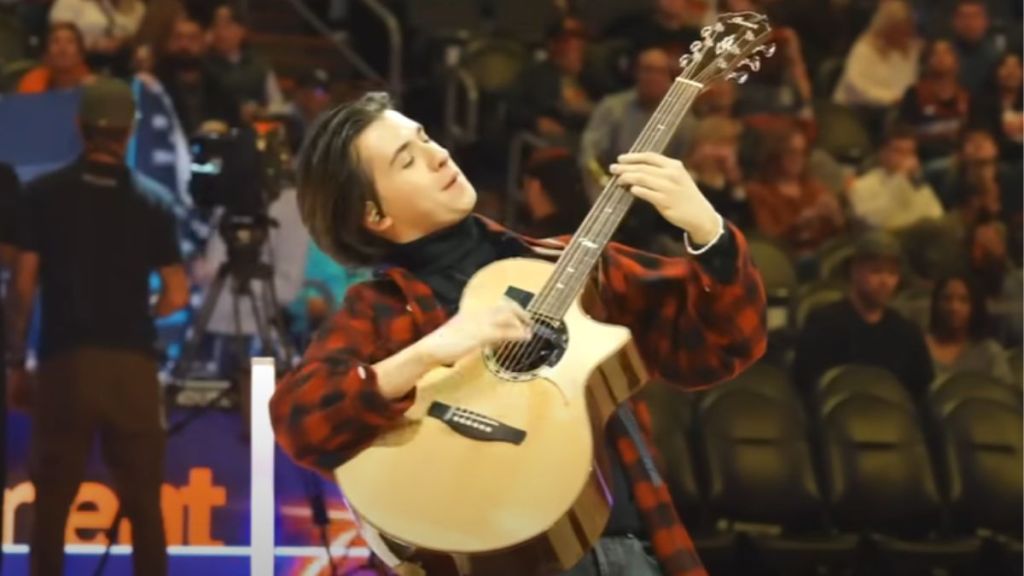 A guitarist delivers an incredible halftime show at a basketball game.