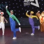 A dance group performs while dressed as Mario characters: Mario, Toad, Luigi, Wario, Donkey Kong, and Yoshi
