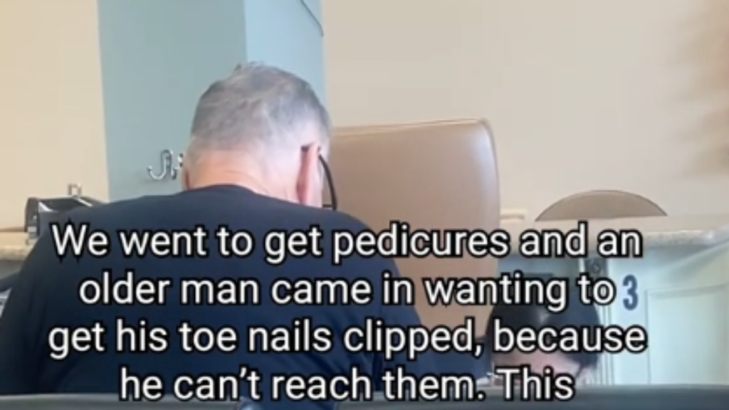 An elderly man at a nail salon getting a pedicure.
