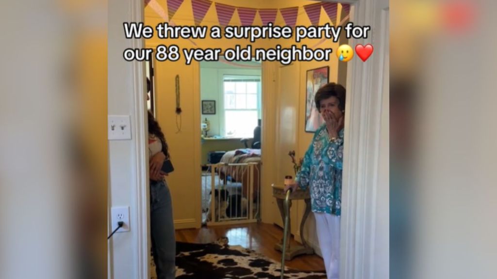 An elderly woman is shocked when she sees her surprise party.
