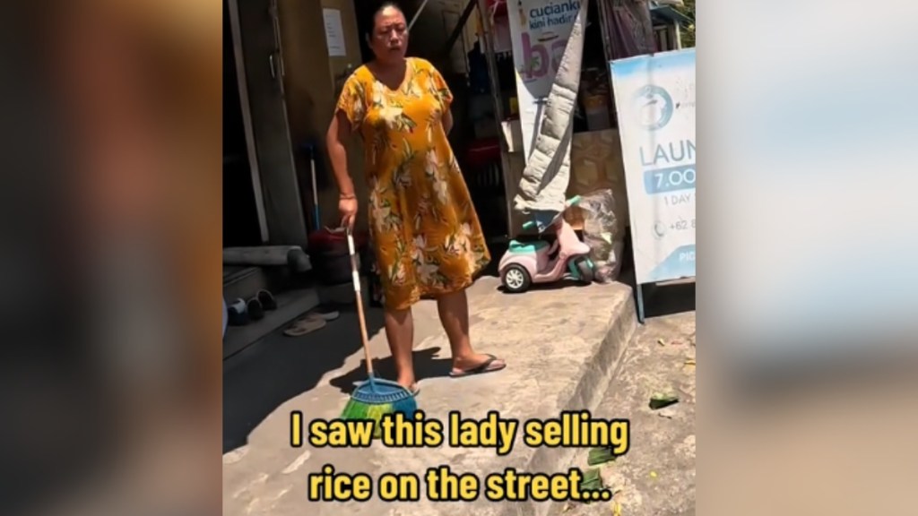 A woman sweeps on the side of a street. Text on the image reads: I saw this lady selling rice on the street...