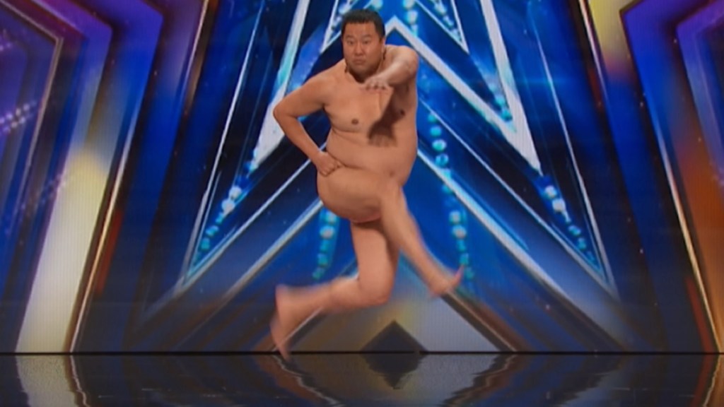 A man who looks naked is jumping but is caught mid-air.