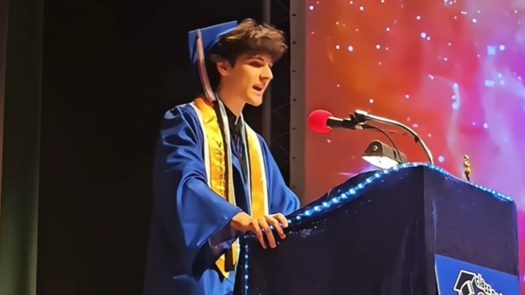 Alem Hadzic stands at a podium giving his valedictorian speech