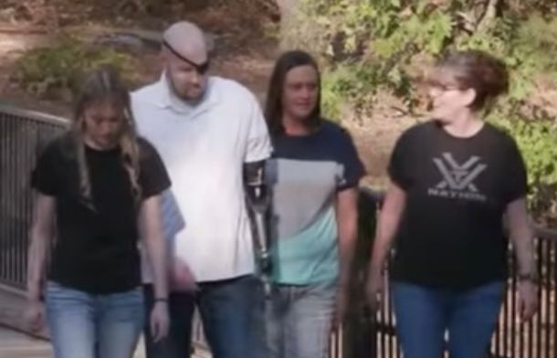 Image shows the James family walking on a path in a park after Aaron James' life-changing surgery.