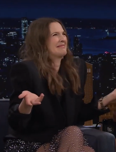 Drew Barrymore making a funny expression in an interview.