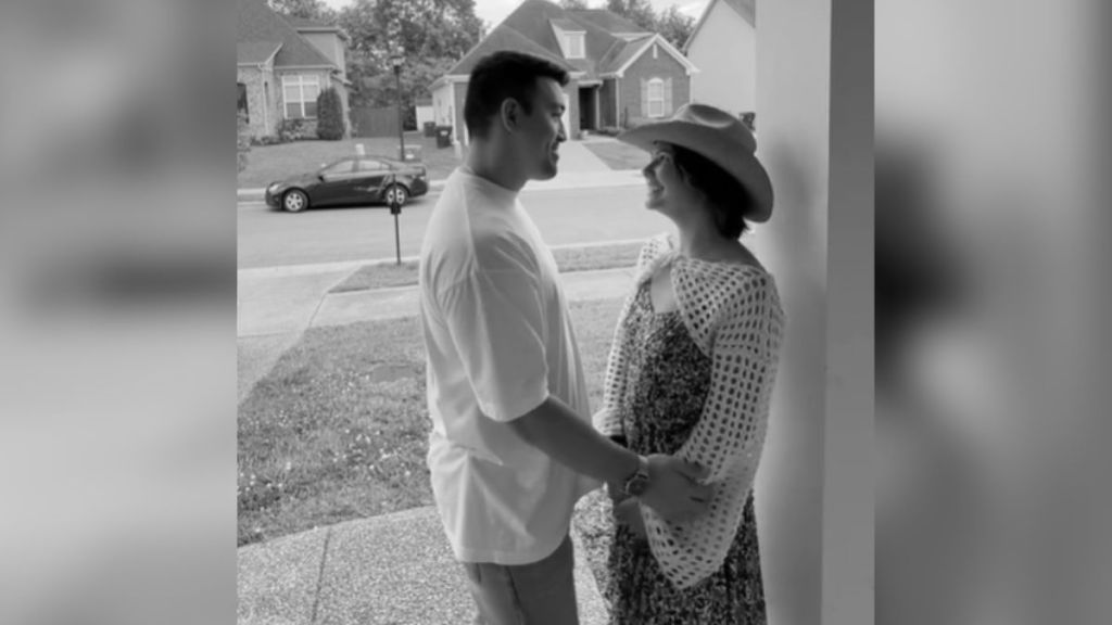 A couple looking at each other before they kiss.