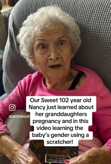 An elderly woman has a surprised expression on her face.
