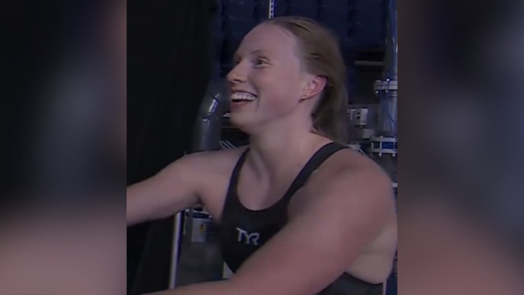 Close up of Lilly King as she smiles wide. She's wearing a swimsuit