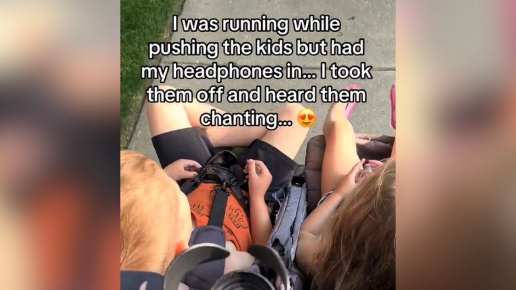 Top-down view of two kids in a stroller. Text on the image reads: I was running while pushing the kids but had my headphones in... I took them off and heard them chanting...