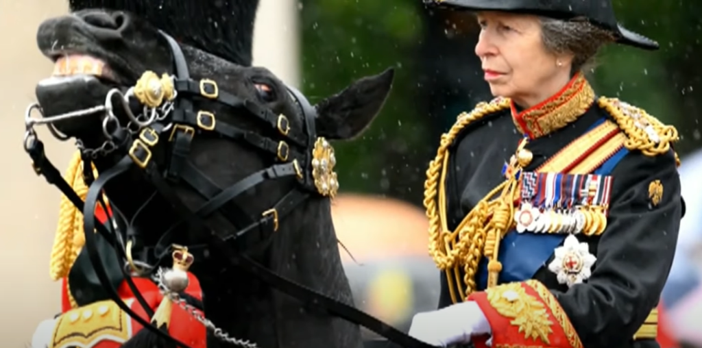 Princess Anne concentrates as she rides a horse.