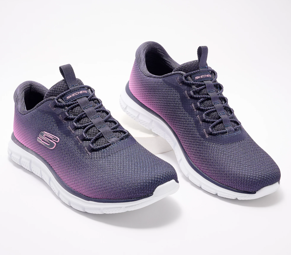 A pair of purple ombre sneakers against a light background.