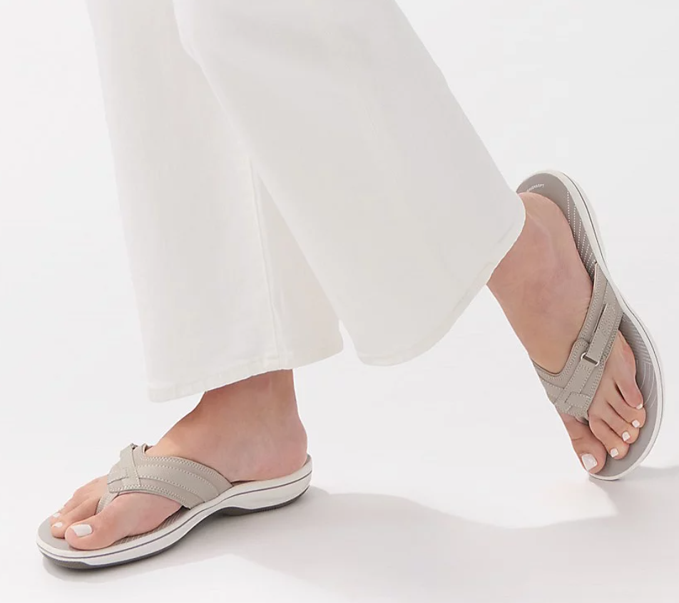 A woman's feet wearing a pair of flip-flops.