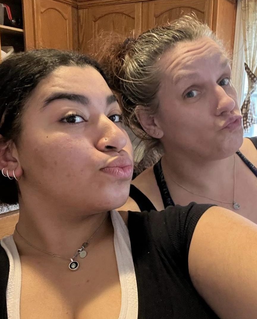 A young woman poses for a selfie with her adopted mom.