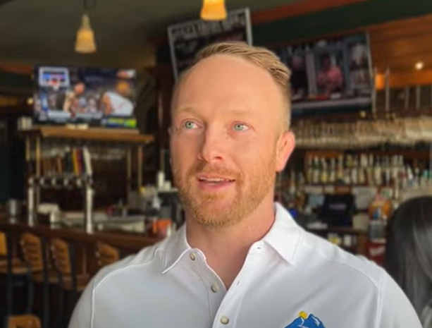 A man telling a story inside a restaurant.