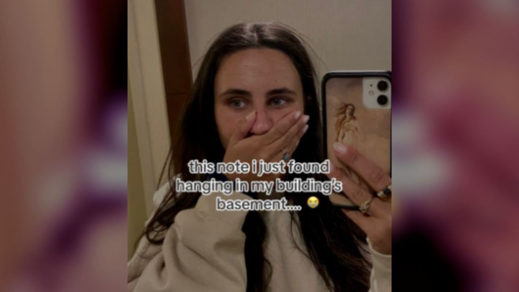 A woman covering her mouth after finding something unexpected.