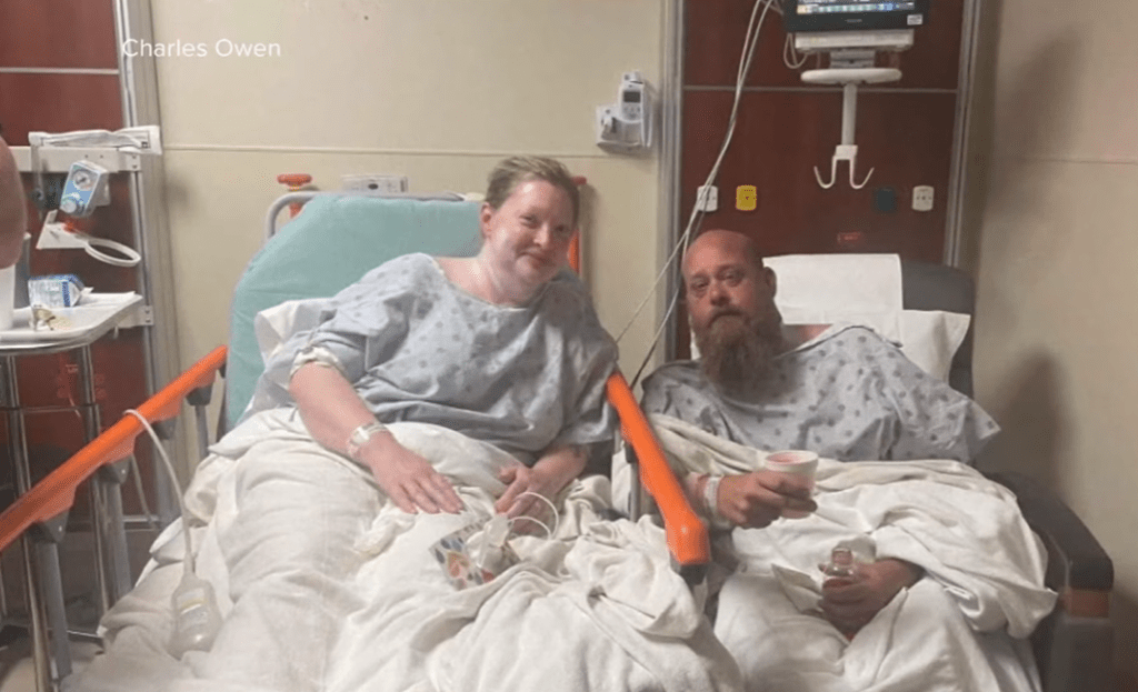 Nathan and Kim in a hospital after their rescue. Kim sits in a bed while Nathan sits in a chair right next to each other.