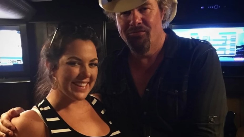 Krystal Keith and her dad, Toby Keith, smile as they pose for a photo