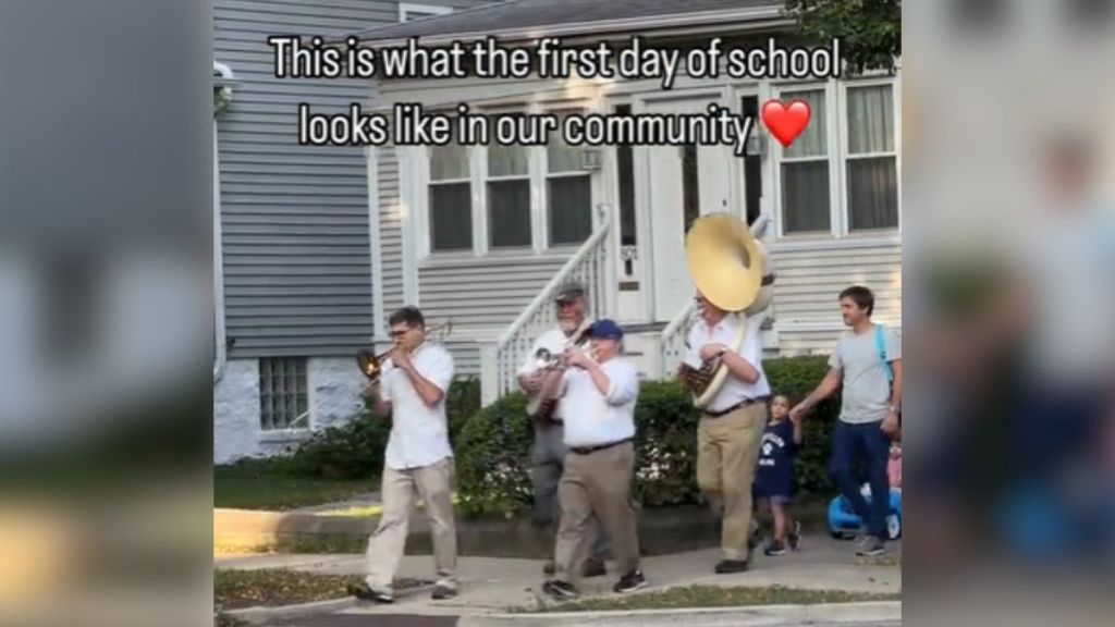 A parade walking through a residential neighborhood.