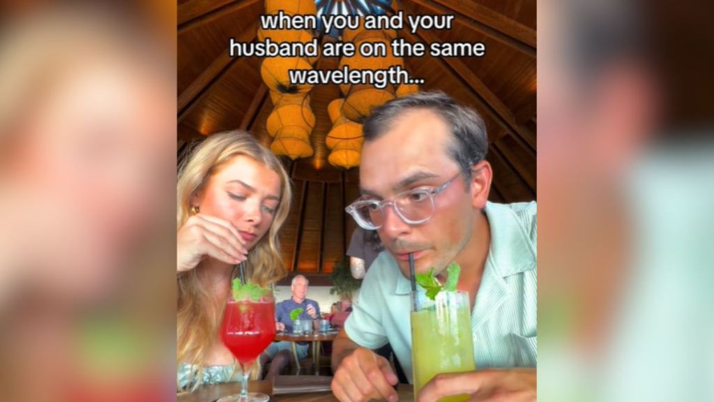 A husband and wife tasting their drinks at a restaurant.