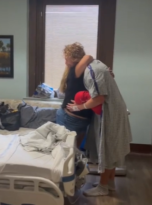 A kidney donor hugging the patient's wife at the hospital.